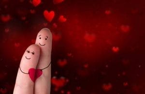 happy couple with hearts on finger