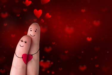 happy couple with hearts on finger